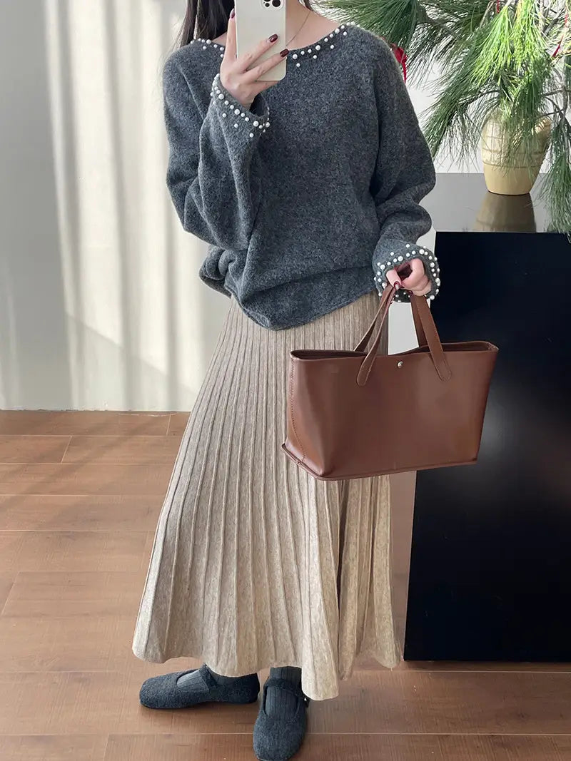brown leather tote bag with top handles and minimalist design paired with korean elastic waist knitted pleated midi skirt