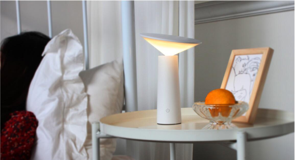 A sleek white minimalist touch table lamp usb led with a modern design and softly glowing warm light ideal for led reading.