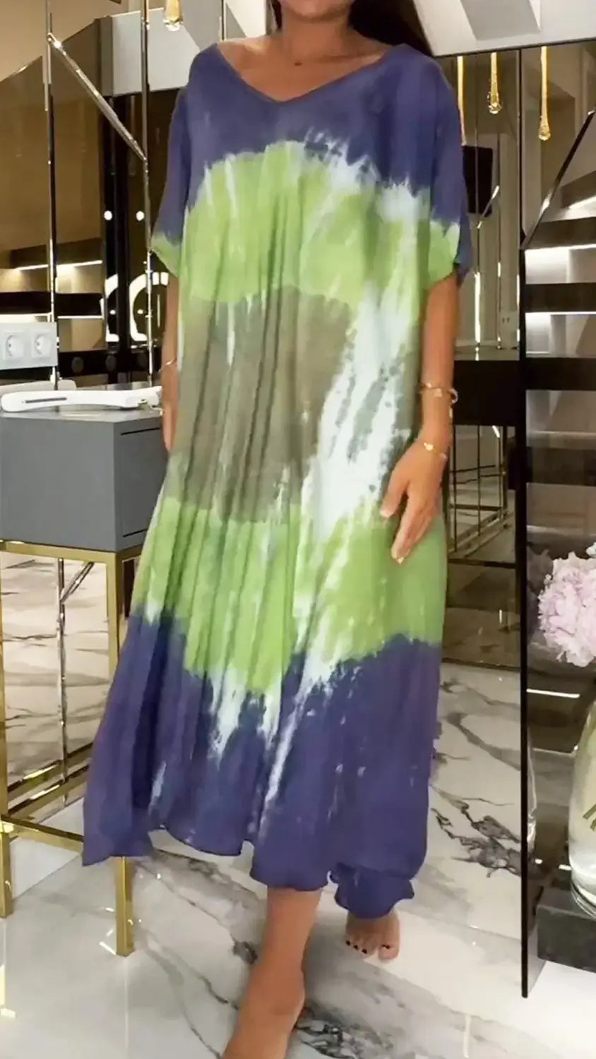a flowing tie-dye maxi dress in shades of green and purple featuring a v-neckline and loose short sleeves as a round neck loose short sleeve maxi dress alternative