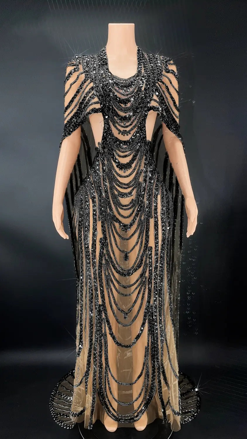 A glamorous black red beaded celebrate crystal sequin evening gown with cascading rows of sequins and sheer mesh fabric displayed on a mannequin.