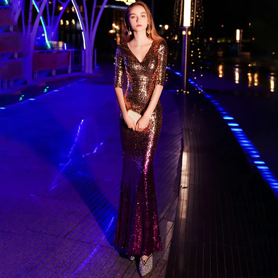 A shimmering gold-to-purple sequined annual meeting gown made of polyester fiber with a v-neck and three-quarter sleeves.