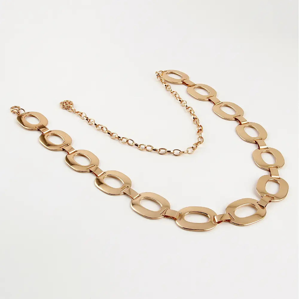 Gold-toned jewelry waist chain featuring oval-shaped links connected by a delicate chain ideal as summer jewelry waist accessory.