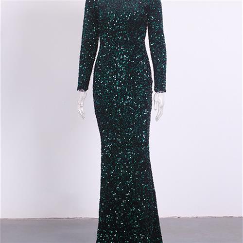 a women modest stretch sequin gown in shimmering emerald green with long sleeves and a fitted silhouette for elegant evening wear