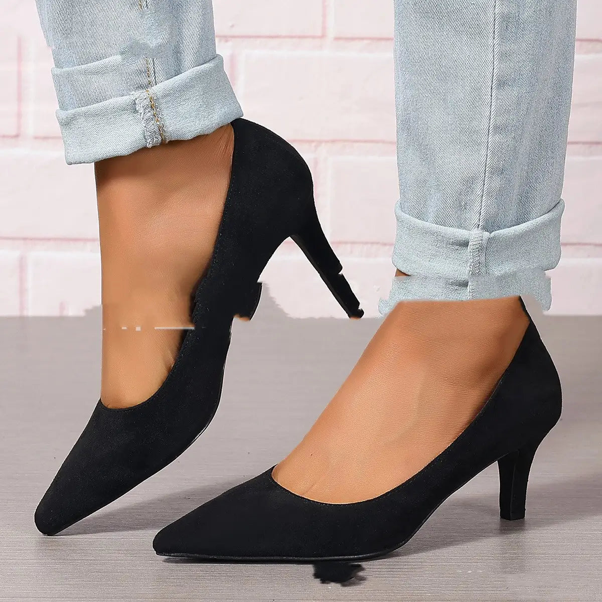 black suede pointed-toe pumps with a sleek low stiletto heel designed as fashion ladies stiletto heel footwear.