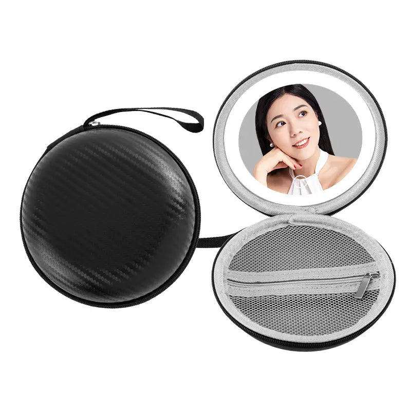 Black carbon fiber-textured round bag blue travel case with built-in round mirror and mesh interior compartment.