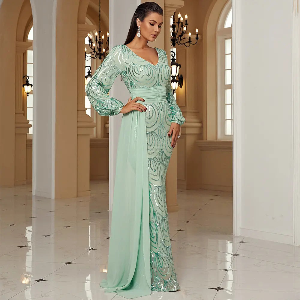 A shimmering mint green long sleeve sexy sequined evening dress with a fitted bodice and flowing skirt featuring intricate sequin detailing.