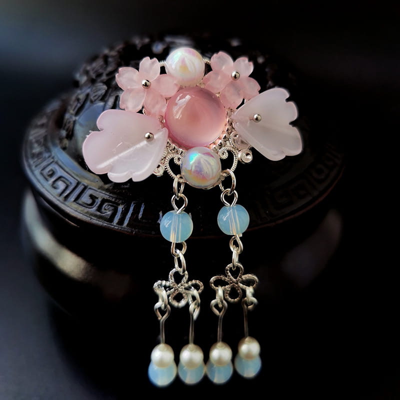 A delicate pink floral retro headgear girls hairpin adorned with translucent gemstones silver filigree and dangling blue opal beads and pearl drops.