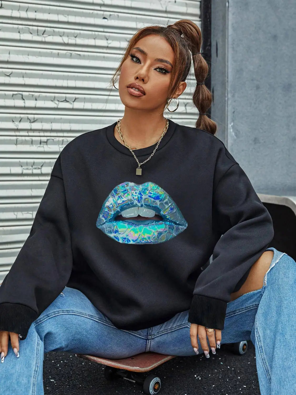 Black women’s crew neck long sleeve sweatshirt featuring a vibrant iridescent blue and teal lips graphic with a glossy textured finish
