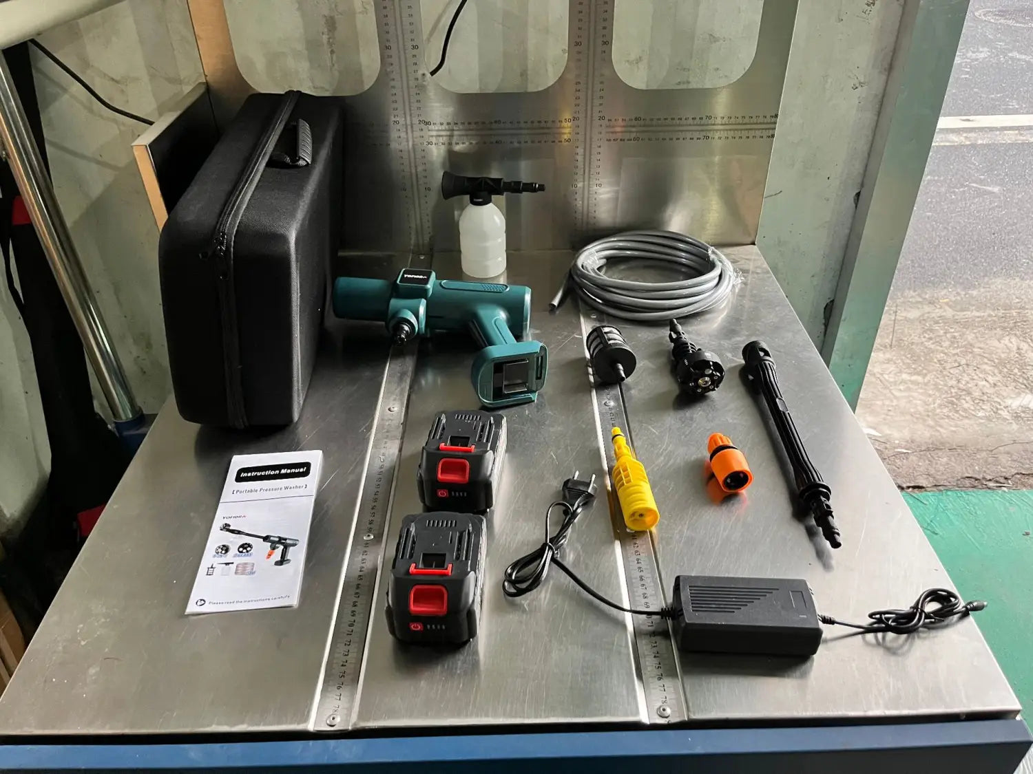 Teal and black multifunctional car wash cordless pressure washer with high pressure hose, nozzle attachments, and battery packs for wash high pressure cleaning.