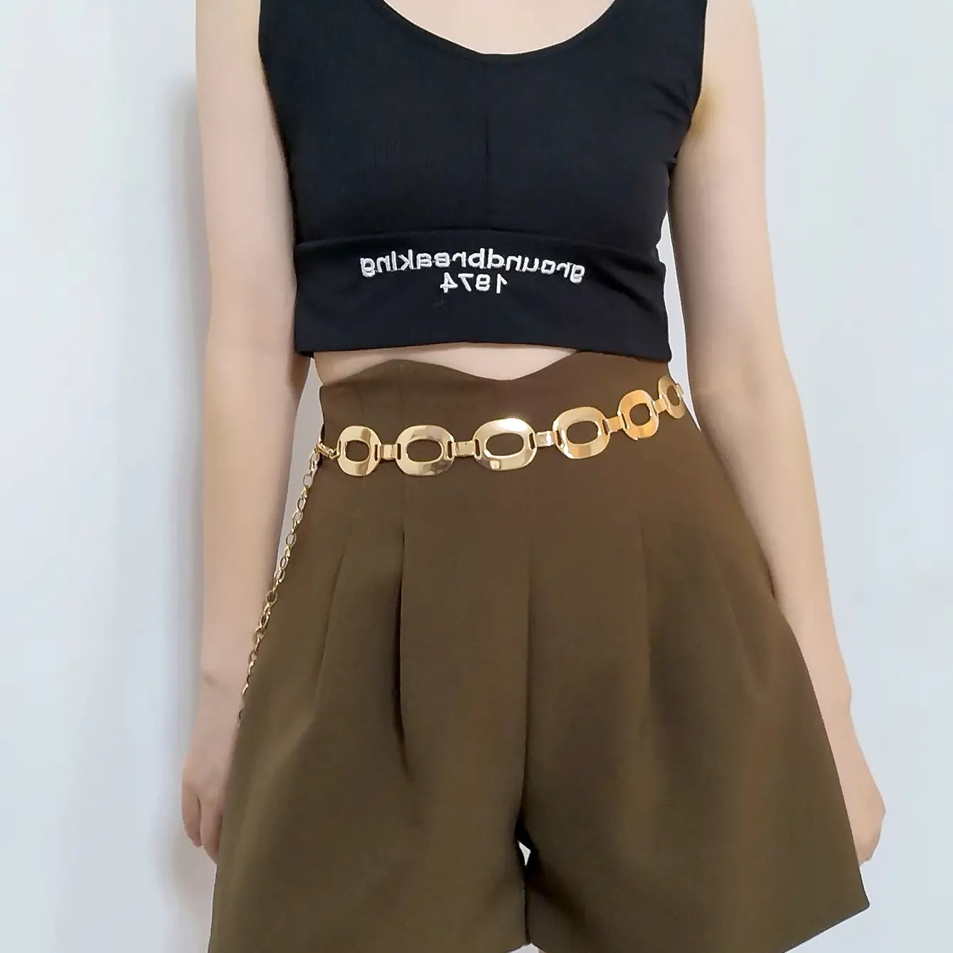 Gold-toned jewelry waist chain featuring interlocking oval links and a delicate chain extension ideal for summer jewelry waist styling.
