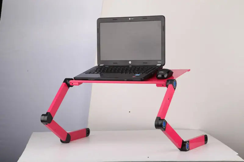 Pink adjustable folding ergonomic laptop table stand with black joints and blue accents designed for comfortable use with a mouse pad and laptop.