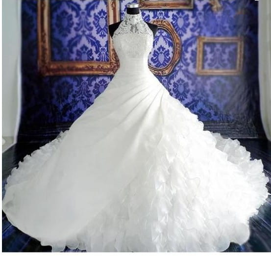 a white voluminous wedding dress wholesale featuring a fitted bodice with intricate beading and lace detailing perfect for bridal occasions