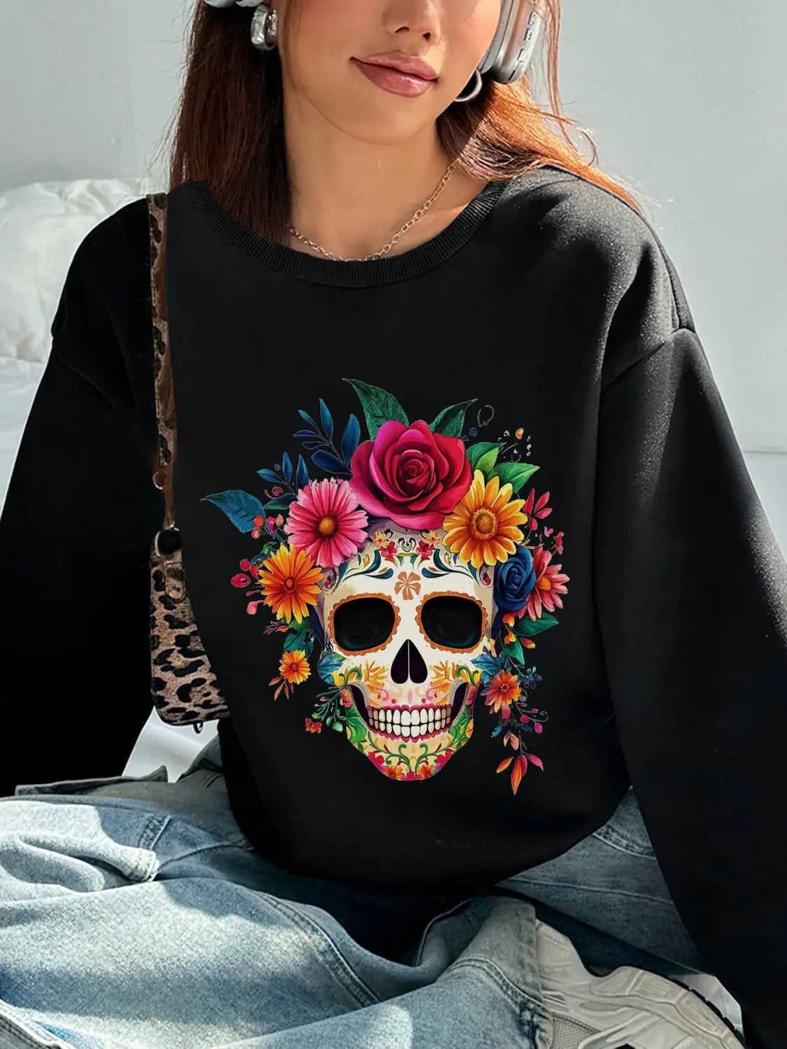 Black crew neck sweatshirt featuring a vibrant colorful sugar skull design adorned with roses and flowers ideal for daily wear basic long sleeve use.