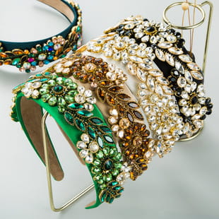 a collection of baroque vintage court style headbands in vibrant green gold and black hues adorned with intricate floral patterns made from sparkling rhinestones
