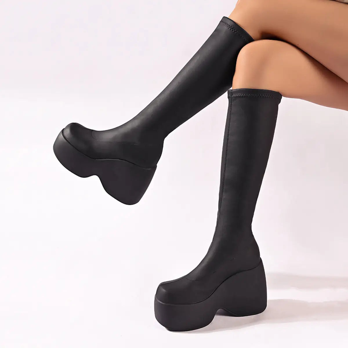 black platform knee high elastic leather boots with sleek stretchy material and bold wedge soles