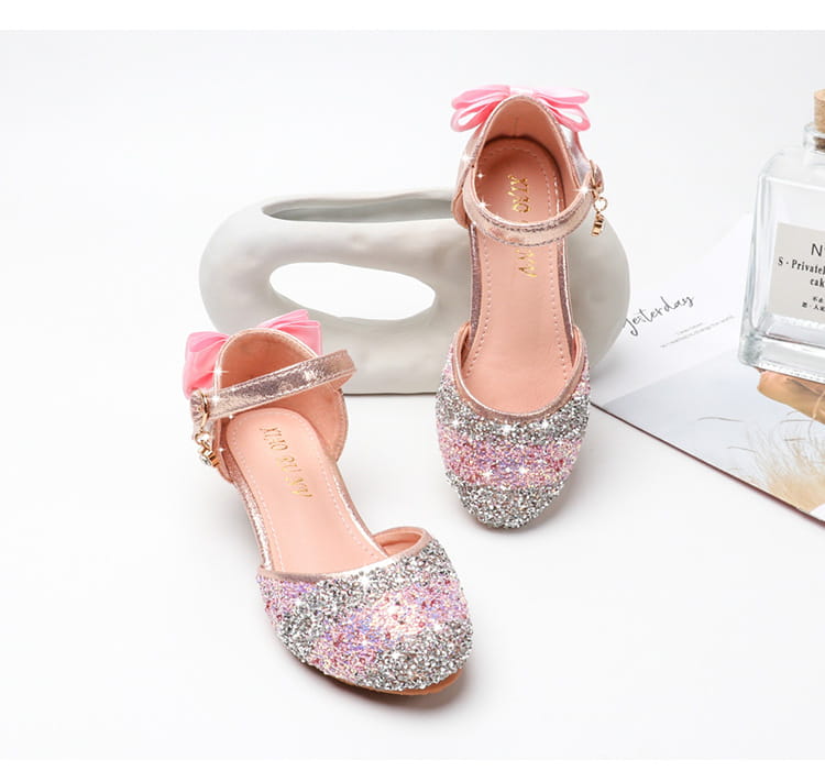 pink and silver glittery girls high heel summer sandals with a bow on the ankle strap and rhinestone sparkling details