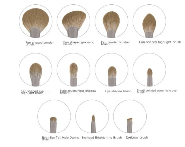 Set of ten makeup brushes with light brown synthetic bristles and silver-colored handles in a premium pink and black makeup brush set.