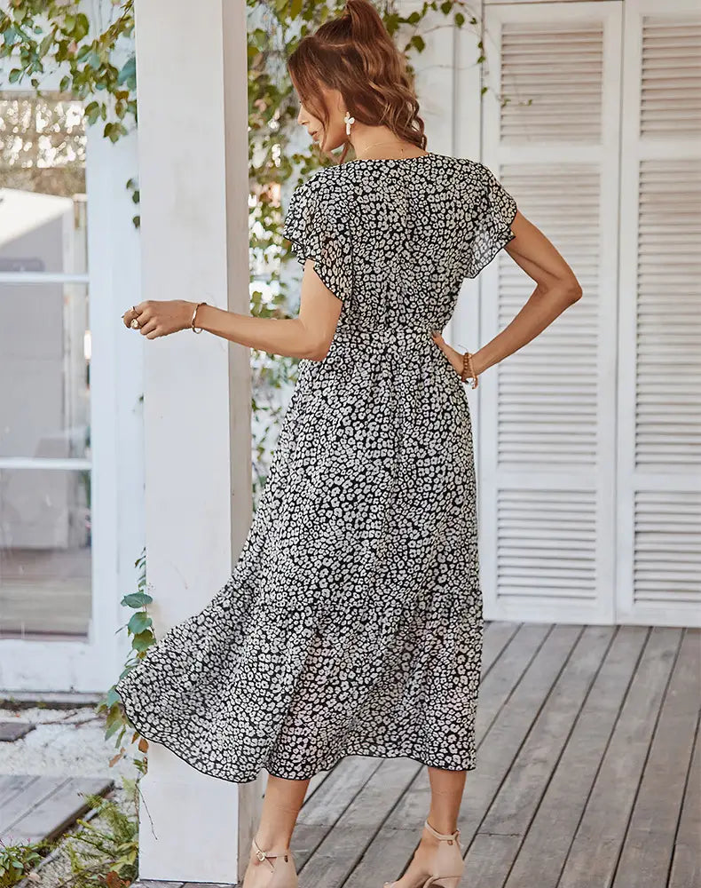 a flowing black and white floral print midi dress with short flutter sleeves featuring ruffle cap sleeves ideal for summer dresses ruffle styles
