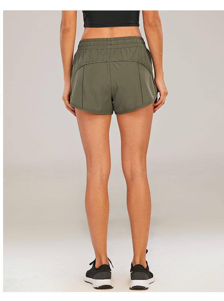 olive green athletic summer sports shorts with stretchy elastic waistband and subtle side paneling featuring zipper pockets breathable for loose comfort during workouts