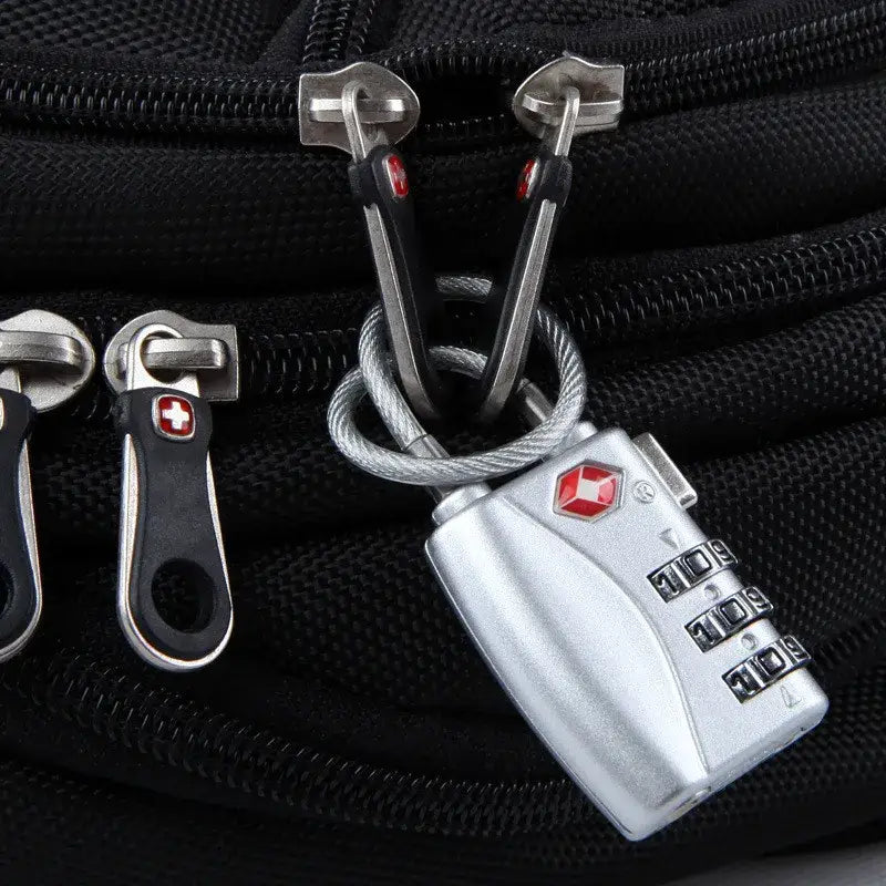 Silver Swiss Army combination travel cable lock with red logo attached to a black backpack via metal carabiners and cable, TSA approved suitcase travel cable lock.