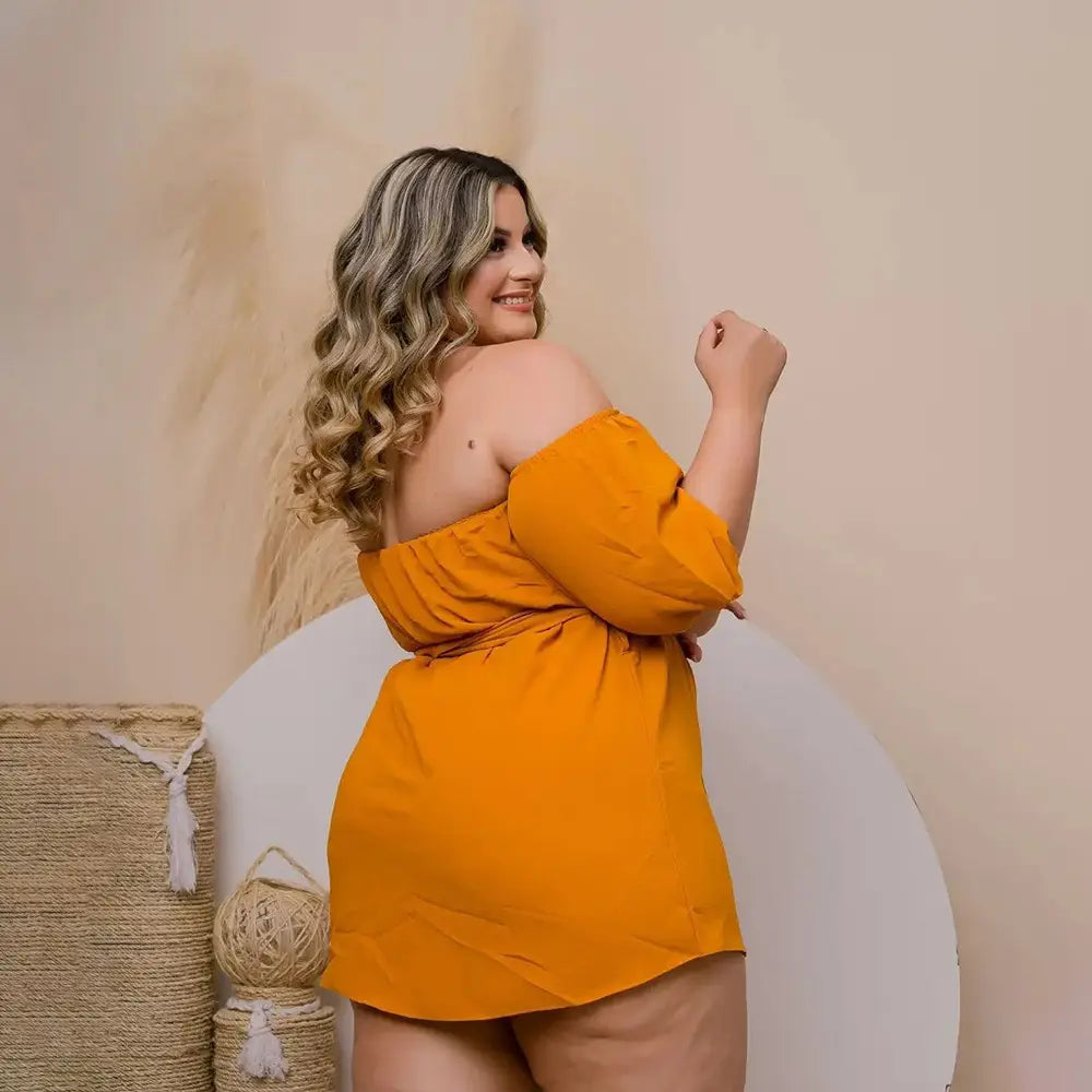 plus size ladies vibrant orange off the shoulder dress with three quarter sleeves and a cinched waist ideal for comfort stretch shorts styling