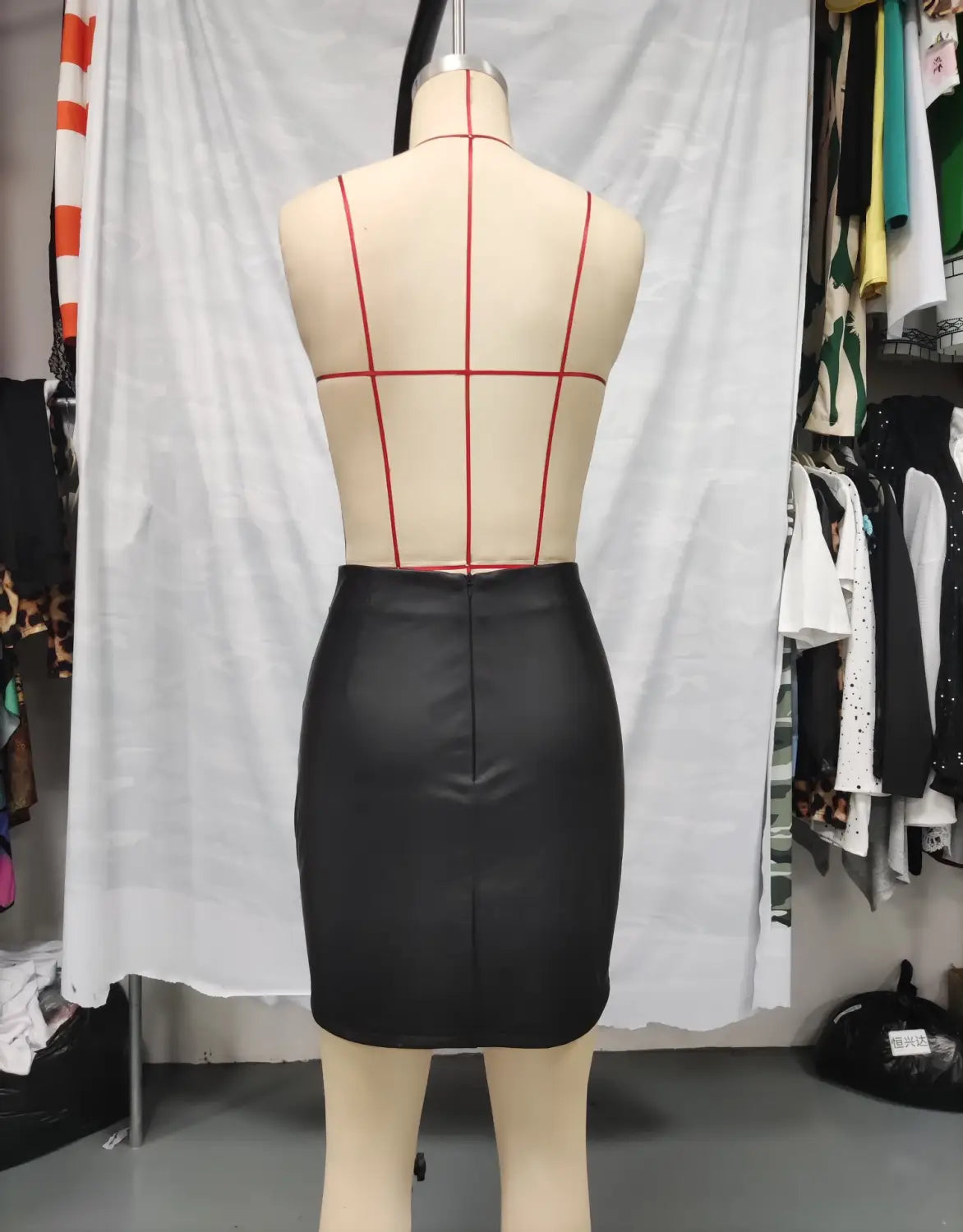 black high waist tight pu leather mini skirt with ruched details and a smooth glossy finish featuring a center front seam