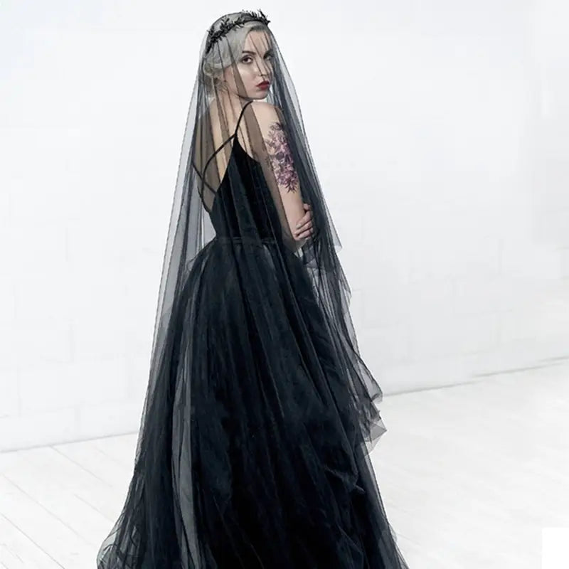 Black velvet gown with a sheer wedding black veil and floral headpiece designed for a bride wedding look