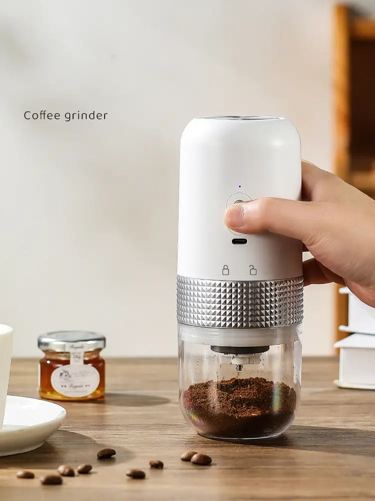 white and silver portable electric ceramic coffee grinder with a textured metallic band and usb charging feature