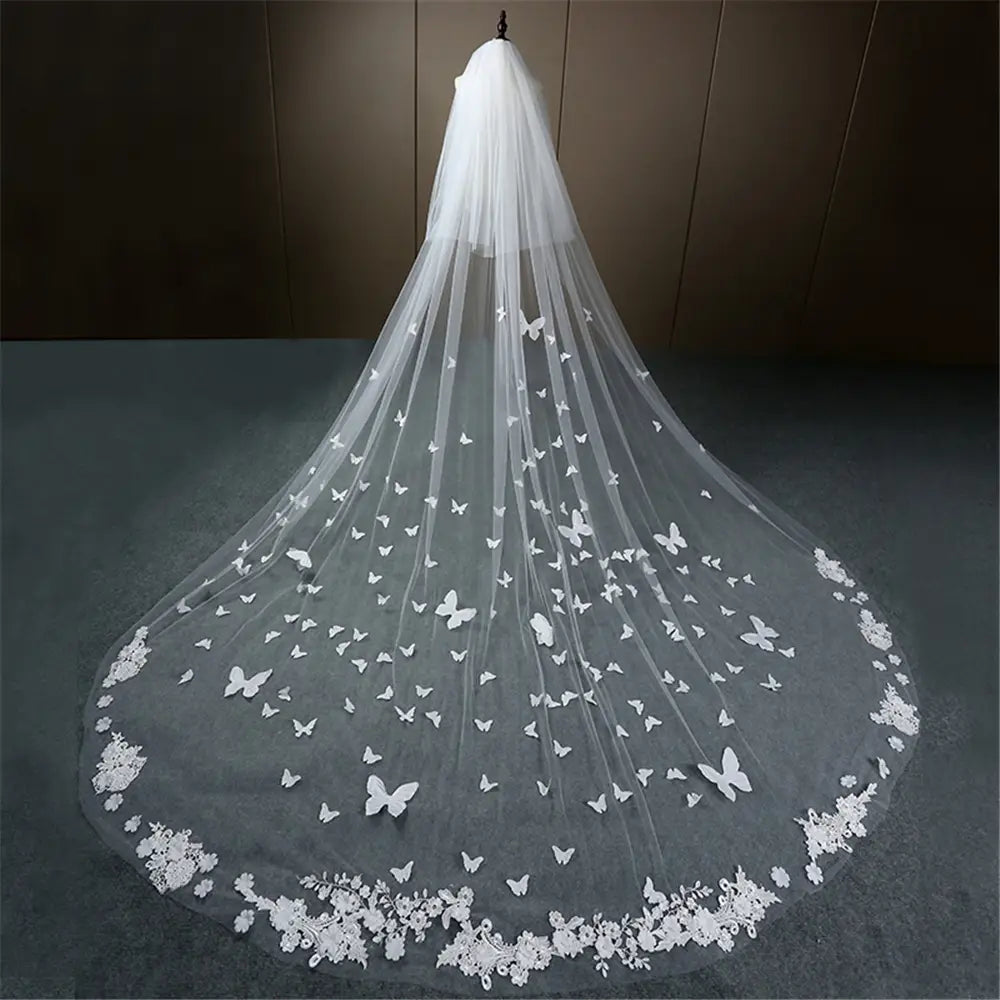 a delicate white veil bridal wedding dress adorned with intricate lace trim and butterfly appliqués featured in the butterfly lace sky veil collection