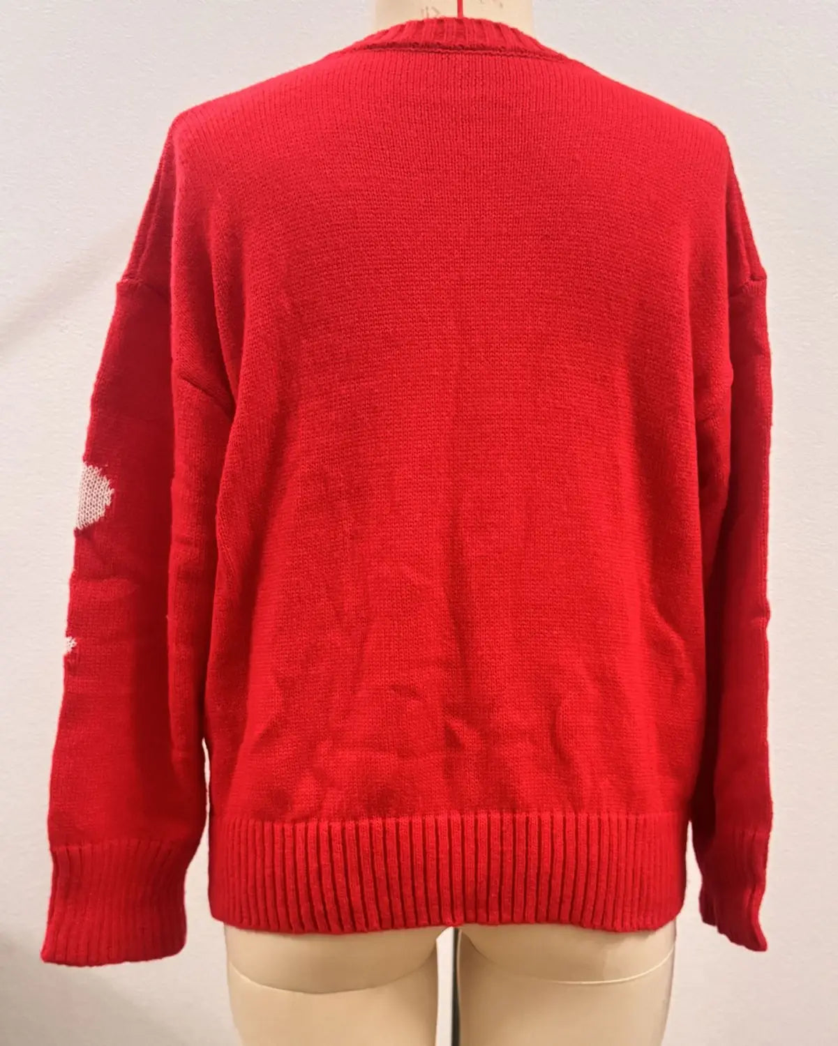 Red knitted Christmas 3d floral sweater with a ribbed hem and cuffs featuring subtle white floral contrast color patchwork on the sleeves in a contrast color crewneck design.