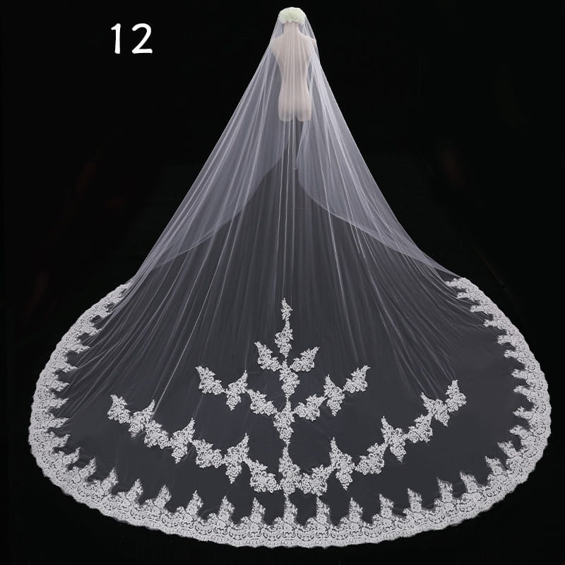 A long lace wedding veil meters wide style features a flowing white lace design with intricate floral embroidery along the hem and a delicate sheer mesh texture.
