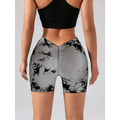 Back view of gray and black abstract branch-patterned high waisted workout shorts with ruched butt lift detailing