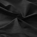 Black women compression skinny leggings fabric with smooth texture and visible stitching along the edge