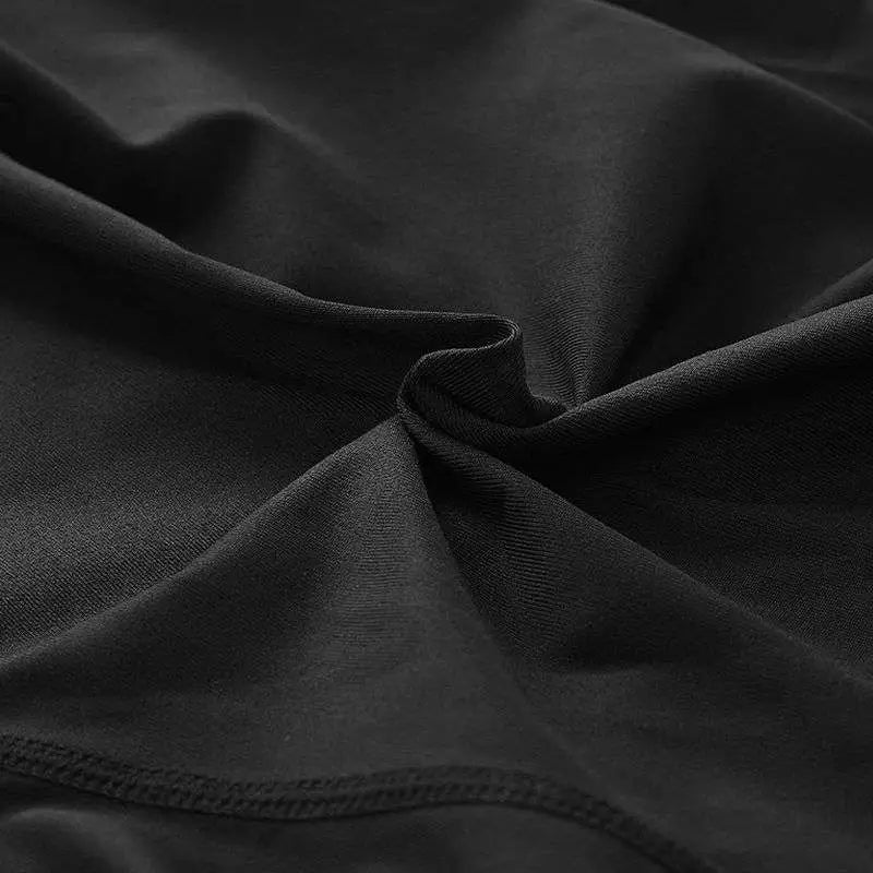 Black women compression skinny leggings fabric with smooth texture and visible stitching along the edge