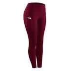 Maroon women compression skinny leggings with high waist and side pocket holding a phone for fitness use