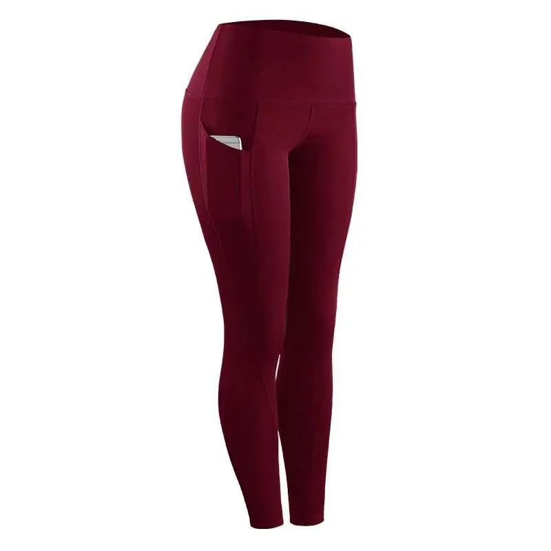 Maroon women compression skinny leggings with high waist and side pocket holding a phone for fitness use
