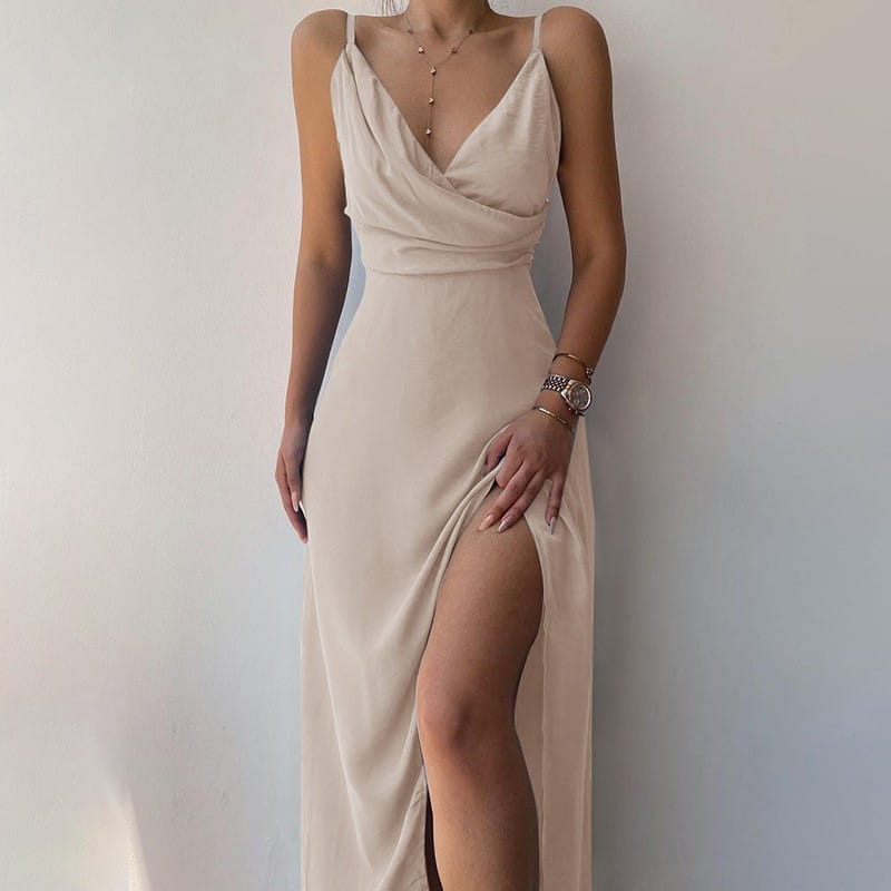 Beige satin slip dress with a deep v-neckline and high slit perfect for dress summer fashion and slit sling dress styles.