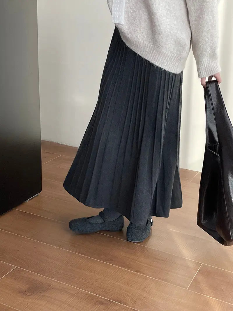 Black korean elastic waist knitted pleated midi skirt with a soft flowing silhouette and subtle texture.