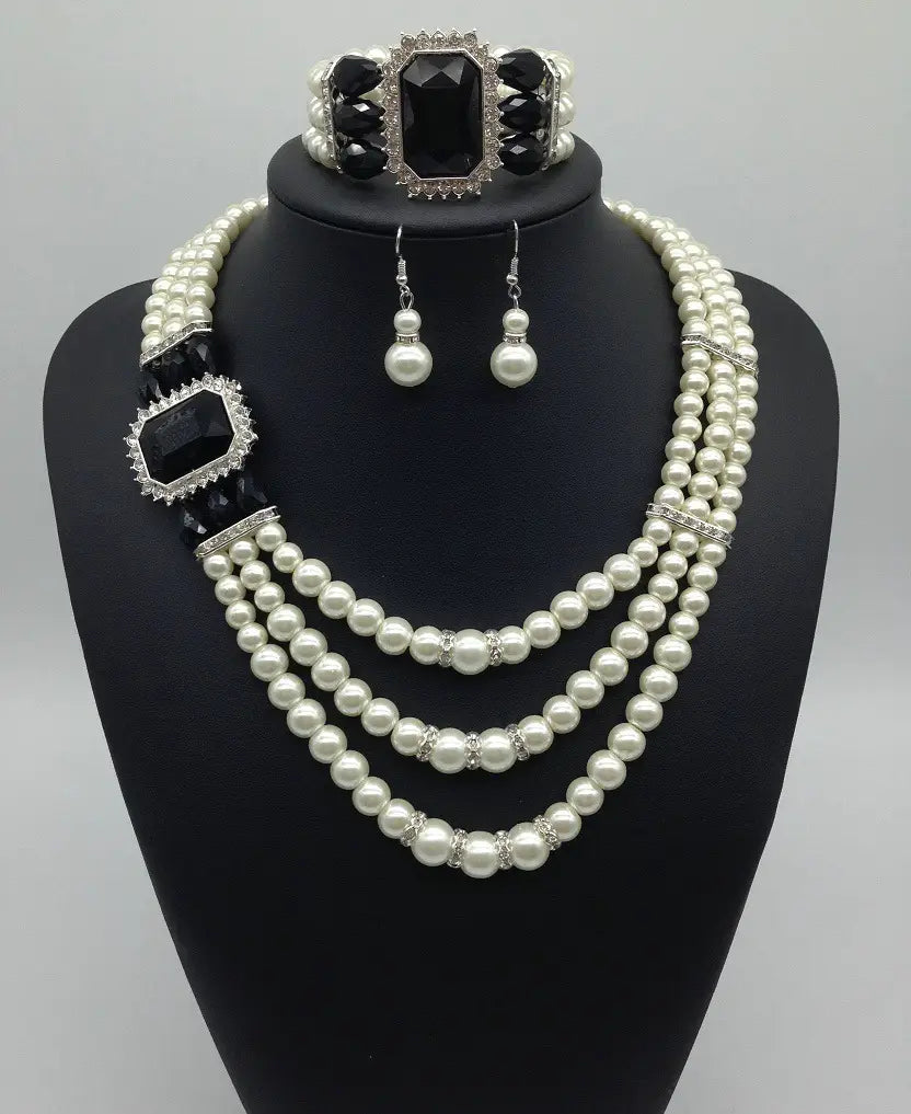 Elegant european fashion diamond gemstone pearl jewelry set featuring a three-strand pearl necklace with black onyx accents and silver-toned crystal embellishments paired with matching earrings and bracelet