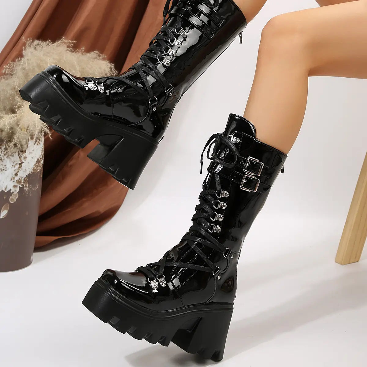 Black versatile casual leather platform boots featuring black patent leather with silver-toned buckles and laces.