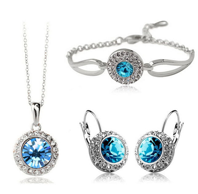Korean style silver jewelry set featuring a central blue crystal surrounded by smaller clear crystals in a fruit green inspired design.