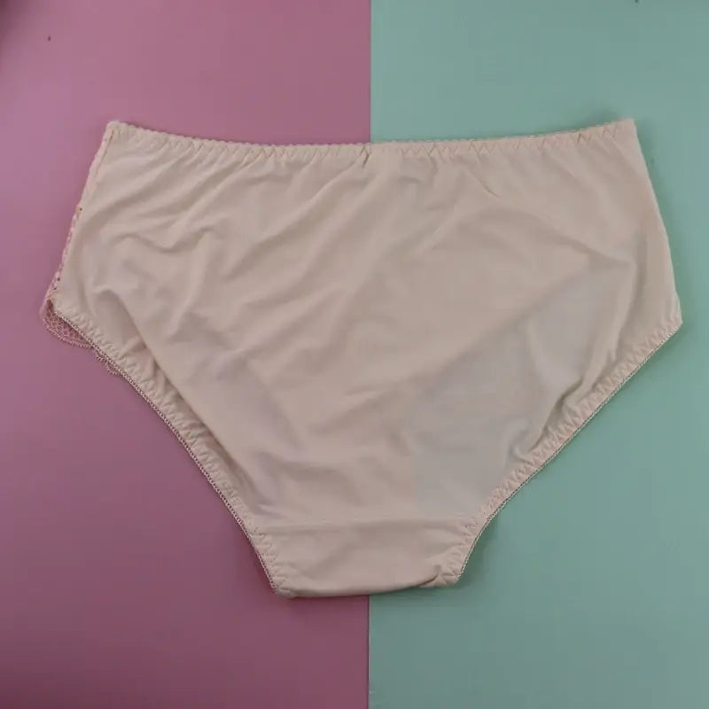 beige cotton plus size underwire briefs featuring delicate lace trim along the leg openings.