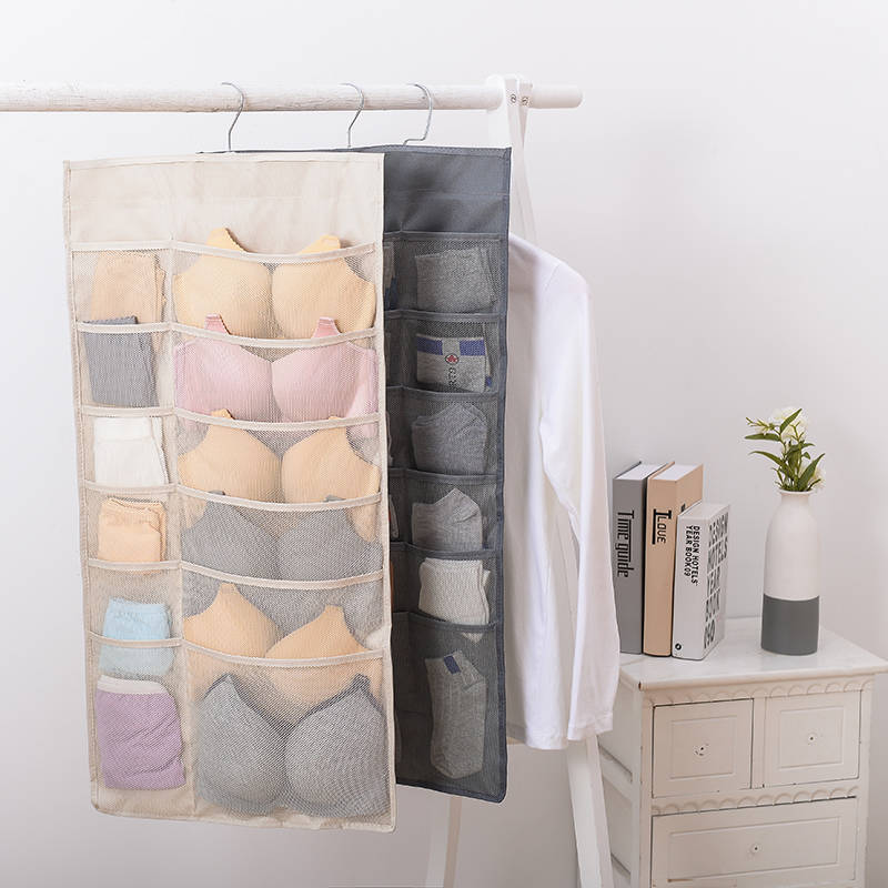 beige and gray mesh hanging storage bag with multiple compartments for organizing bras and underwear on a rod
