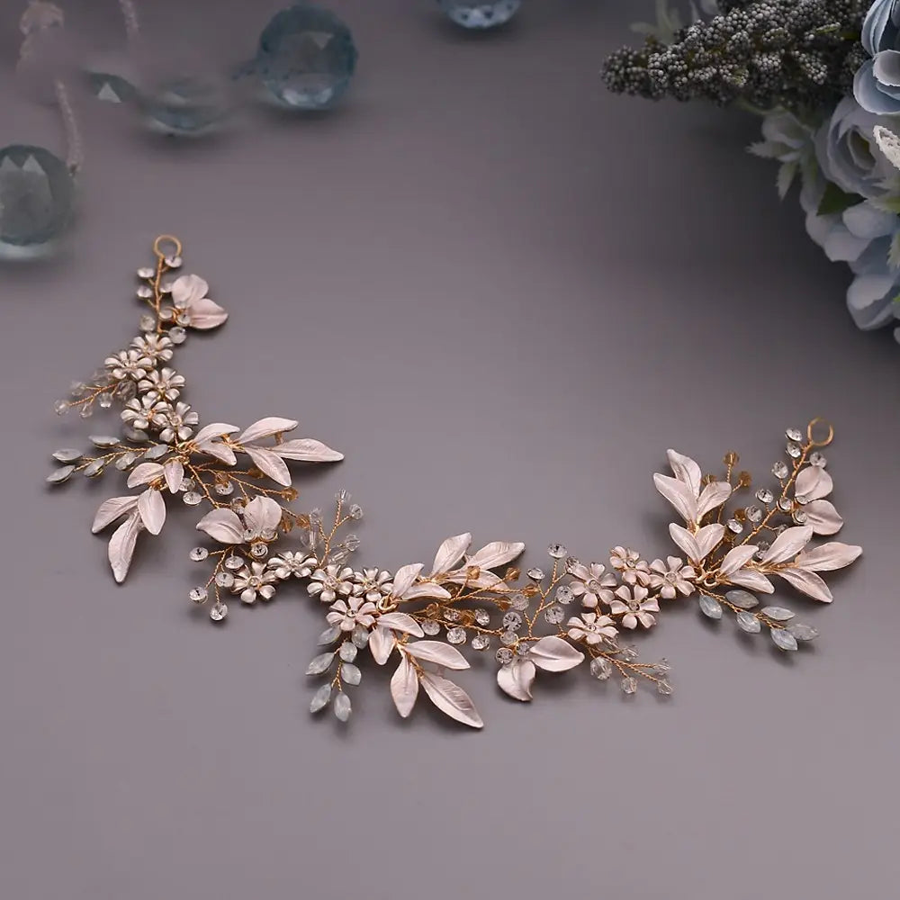 A delicate rose gold floral headpiece made of alloy crystals japan featuring pale pink and clear crystal embellishments for elegant hair accessories.