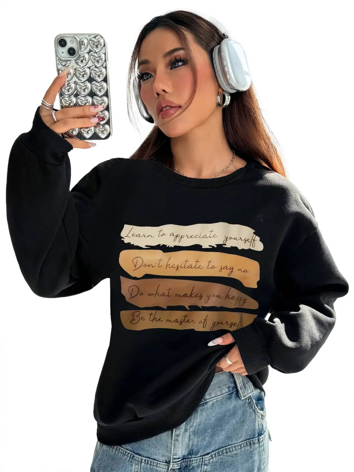 Black oversized long sleeve sweatshirt with motivational quotes printed in beige and gold tones across the chest for daily wear solid colour style.