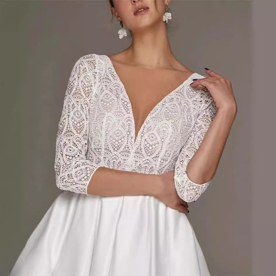 white lace bridal deep v-neck long sleeve wedding dress with three-quarter sleeves and elegant lace detailing