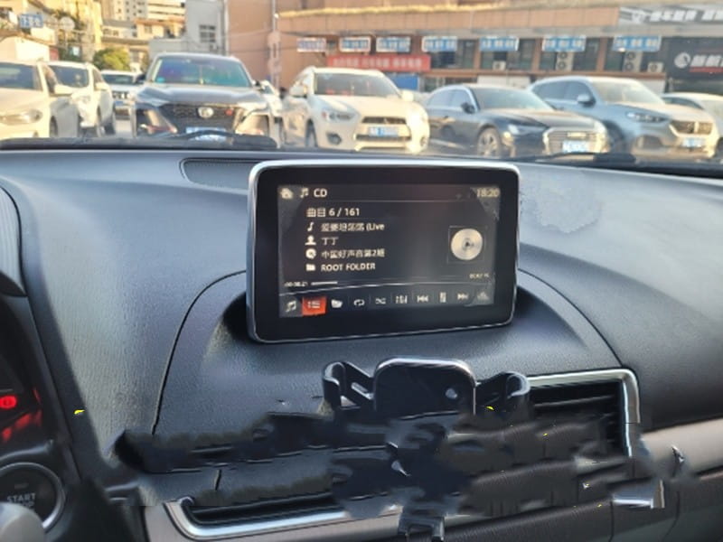 black smartphone mounted in a car dashboard holder displaying music playback screen with chinese text as part of original car exterior screen replacement touch screen product