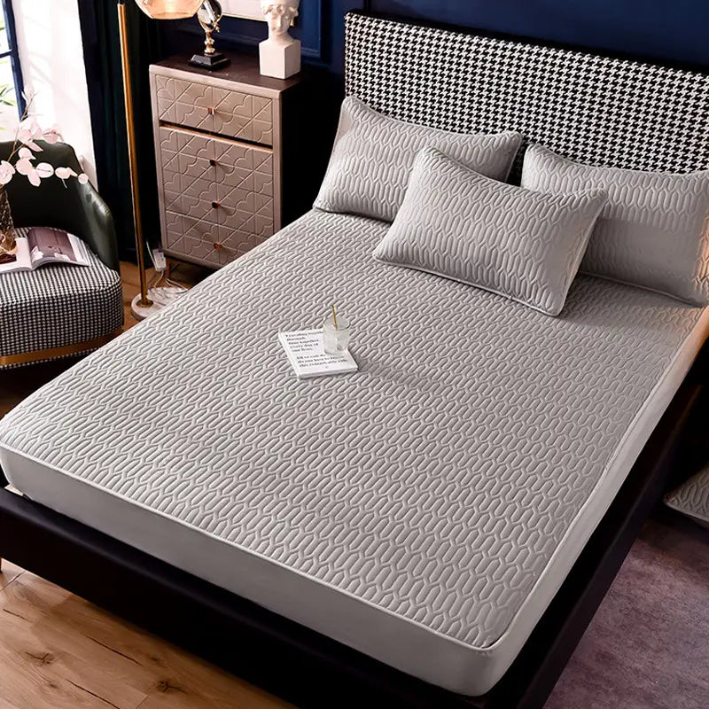 Gray quilted bed pad featuring a subtle geometric pattern on the back side of a thickened all-inclusive dust-proof single-piece fitted sheet.