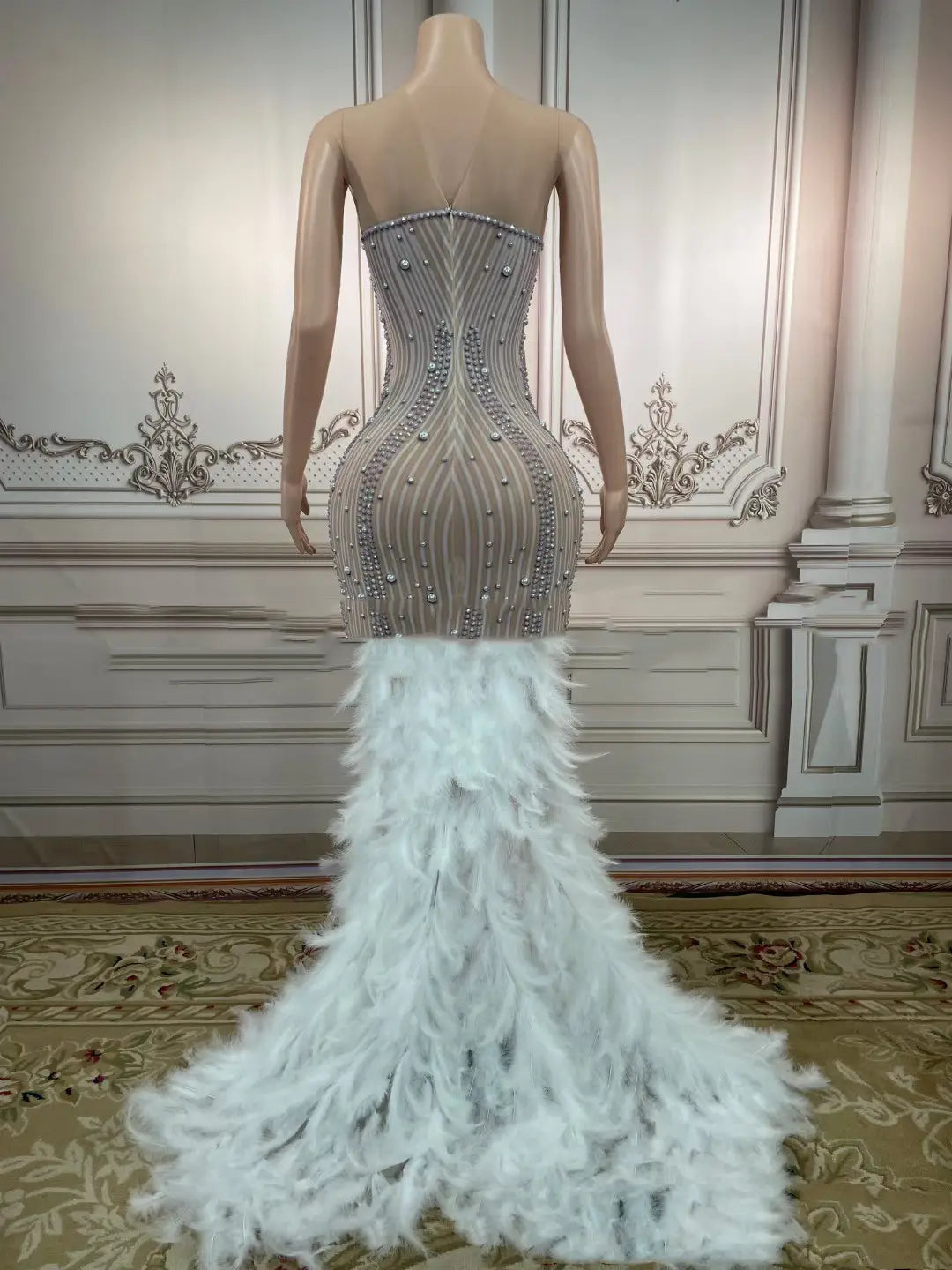 silver feathered hips nightclub bar strapless mermaid gown with corseted bodice adorned in silver beading and white feathers cascading down the back shown from the back side