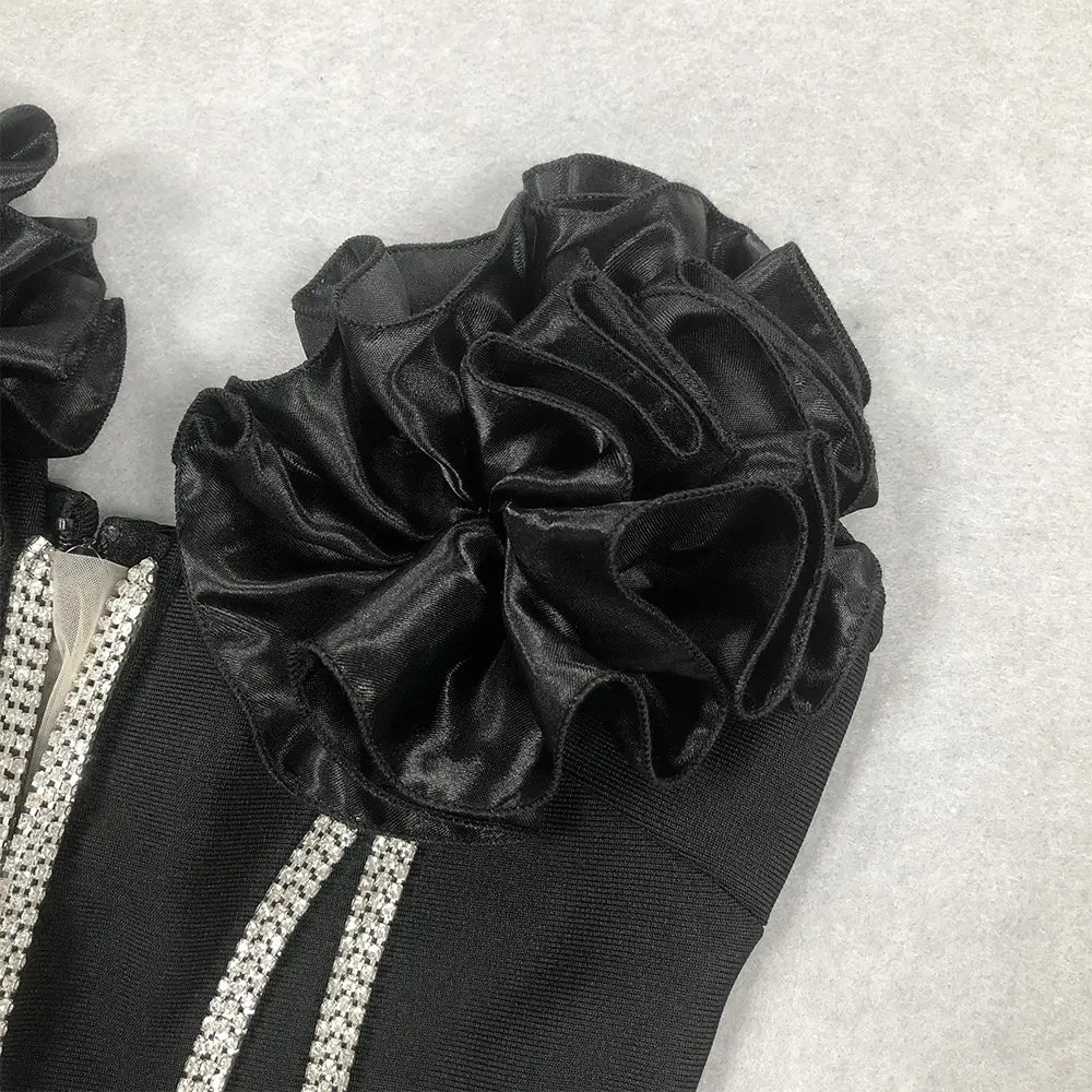 a white temperament socialite flower chain evening dress featuring a black velvet ruffle embellishment with a glossy finish accented by silver rhinestone trim